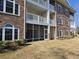 Brick building with screened porch and landscaping at 703 Riverwalk Dr. # 103, Myrtle Beach, SC 29579