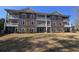 Brick building exterior with balconies and landscaping at 703 Riverwalk Dr. # 103, Myrtle Beach, SC 29579