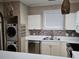 Kitchen with white cabinets, tile backsplash, and stainless steel appliances at 703 Riverwalk Dr. # 103, Myrtle Beach, SC 29579