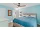 Bright bedroom with a blue quilt on the bed and an ensuite bathroom at 719 N Waccamaw Dr., Garden City Beach, SC 29576