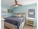 Comfortable bedroom with neutral colors, a ceiling fan and a pair of windows at 719 N Waccamaw Dr., Garden City Beach, SC 29576