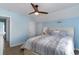 Light blue bedroom with a ceiling fan, nice bedding and a white door at 719 N Waccamaw Dr., Garden City Beach, SC 29576