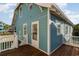 Charming teal home with a wooden deck, white trim, and easy access from the side at 719 N Waccamaw Dr., Garden City Beach, SC 29576
