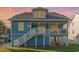 Inviting two-story beach home with elevated deck and classic coastal charm at 719 N Waccamaw Dr., Garden City Beach, SC 29576