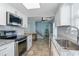 Bright kitchen features stainless appliances, white cabinets and stone countertops at 719 N Waccamaw Dr., Garden City Beach, SC 29576