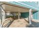 Spacious under-house area with concrete flooring, support pillars, and an outdoor shower at 719 N Waccamaw Dr., Garden City Beach, SC 29576