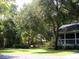 Lush backyard with mature trees surrounding the property creates a private retreat at 76 Nailah Ln., Pawleys Island, SC 29585