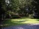 Beautiful backyard with mature trees surrounding the property creates a private retreat at 76 Nailah Ln., Pawleys Island, SC 29585