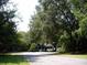 Secluded home surrounded by mature trees, providing shade and privacy at 76 Nailah Ln., Pawleys Island, SC 29585