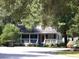 Charming home with a screened-in porch and a red front door at 76 Nailah Ln., Pawleys Island, SC 29585