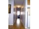 Long hallway with hardwood floors and recessed lighting leading to the bedroom at 76 Nailah Ln., Pawleys Island, SC 29585