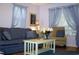 Living room featuring a comfortable sofa, chair, and stylish decor with natural lighting at 76 Nailah Ln., Pawleys Island, SC 29585