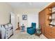 Cozy office with teal armchair and built-in wooden shelving at 799 Helms Way, Conway, SC 29526