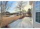 Scenic backyard featuring a patio, lush lawn, mature trees, and pond views for relaxation at 8304 Parasol Ct., Myrtle Beach, SC 29579