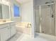 Bright main bathroom featuring a tub, shower, and large window at 8304 Parasol Ct., Myrtle Beach, SC 29579