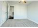 A well-lit bedroom showcases plush carpet, a ceiling fan, and neutral walls at 8304 Parasol Ct., Myrtle Beach, SC 29579