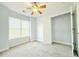 Bright bedroom with large window, ceiling fan, and a closet offers comfort and functionality at 8304 Parasol Ct., Myrtle Beach, SC 29579
