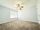 A cozy bedroom is brightly lit with a ceiling fan and window at 8304 Parasol Ct., Myrtle Beach, SC 29579