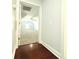 A carpeted hallway enters into a large carpeted bedroom with a ceiling fan and window at 8304 Parasol Ct., Myrtle Beach, SC 29579