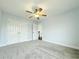 Spacious bedroom has neutral carpet, a ceiling fan, and double doors leading to a closet at 8304 Parasol Ct., Myrtle Beach, SC 29579