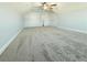 Bedroom with sloped ceiling features neutral carpet, ceiling fan, and two closets at 8304 Parasol Ct., Myrtle Beach, SC 29579