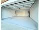 Spacious garage with epoxy flooring, shelving, and a door leading to the home at 8304 Parasol Ct., Myrtle Beach, SC 29579