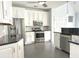 Modern kitchen with stainless steel appliances, granite countertops, and white cabinets and tile backsplash at 8304 Parasol Ct., Myrtle Beach, SC 29579