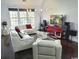 Well-lit living room featuring hardwood floors, white couches, and a large entertainment center at 8304 Parasol Ct., Myrtle Beach, SC 29579