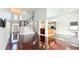 Bright, open-concept living room showcasing hardwood floors, stairs, and seamless flow to kitchen area at 8304 Parasol Ct., Myrtle Beach, SC 29579