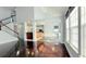 Spacious living room with hardwood floors and bright light from large windows and views of kitchen at 8304 Parasol Ct., Myrtle Beach, SC 29579