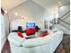 Bright, open living room with plush white couches, modern lighting, and high ceilings near stairs at 8304 Parasol Ct., Myrtle Beach, SC 29579