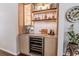 Elegant bar area with custom shelving, a wine fridge, and stylish lighting at 908 Cedarwood Circle, Myrtle Beach, SC 29572