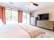 Bright bedroom with dresser and media center, and sliding glass door access to the backyard at 908 Cedarwood Circle, Myrtle Beach, SC 29572