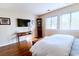 Bright bedroom with hardwood floors, large windows, and a mounted television at 908 Cedarwood Circle, Myrtle Beach, SC 29572