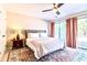 Cozy bedroom featuring a ceiling fan, area rug, and sliding glass door access to the backyard at 908 Cedarwood Circle, Myrtle Beach, SC 29572