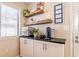 Kitchen nook featuring floating shelves and stainless steel appliances at 908 Cedarwood Circle, Myrtle Beach, SC 29572