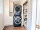 Laundry closet with stacked washer and dryer and storage shelves at 908 Cedarwood Circle, Myrtle Beach, SC 29572