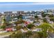 Aerial view of a coastal community with vibrant homes, lush greenery, and ocean proximity at 913 S Dogwood Dr. S, Surfside Beach, SC 29575