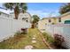 Backyard with lush greenery, a grill, and a stone pathway offering a private outdoor space at 913 S Dogwood Dr. S, Surfside Beach, SC 29575