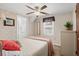 Inviting bedroom with a ceiling fan, a view of an ensuite bathroom, and a serene window view at 913 S Dogwood Dr. S, Surfside Beach, SC 29575