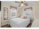 Cozy bedroom with a full bed, ceiling fan, and natural light from the windows at 913 S Dogwood Dr. S, Surfside Beach, SC 29575