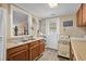 Charming kitchen featuring wood cabinets, a double sink, a vintage oven, and access to the back entrance at 913 S Dogwood Dr. S, Surfside Beach, SC 29575