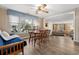 Cozy living space featuring hardwood floors, natural light, dining table, and a view into an open living room at 913 S Dogwood Dr. S, Surfside Beach, SC 29575