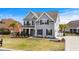 Beautiful two-story home with gray siding, black shutters, manicured lawn and a two car garage at 931 Desert Wheatgrass Dr., Myrtle Beach, SC 29579