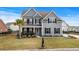 Charming two-story home with gray siding, black shutters, a palm tree, and a well-manicured lawn at 931 Desert Wheatgrass Dr., Myrtle Beach, SC 29579