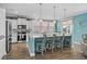 Kitchen with white cabinets, gray island seating and pendant lighting at 931 Desert Wheatgrass Dr., Myrtle Beach, SC 29579