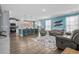 Open floorplan living room with a kitchen island, gray reclining sofa and aqua accents at 931 Desert Wheatgrass Dr., Myrtle Beach, SC 29579