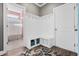 Well-organized mudroom with a bench, cubbies, hooks, and a convenient entrance to an additional bathroom at 931 Desert Wheatgrass Dr., Myrtle Beach, SC 29579