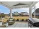 Relaxing screened porch with outdoor seating, decorative rug, and a grill for entertaining at 931 Desert Wheatgrass Dr., Myrtle Beach, SC 29579