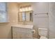 Elegant bathroom with marble countertop vanity, framed mirror, and a view of the window at 9450 Old Palmetto Rd., Murrells Inlet, SC 29576